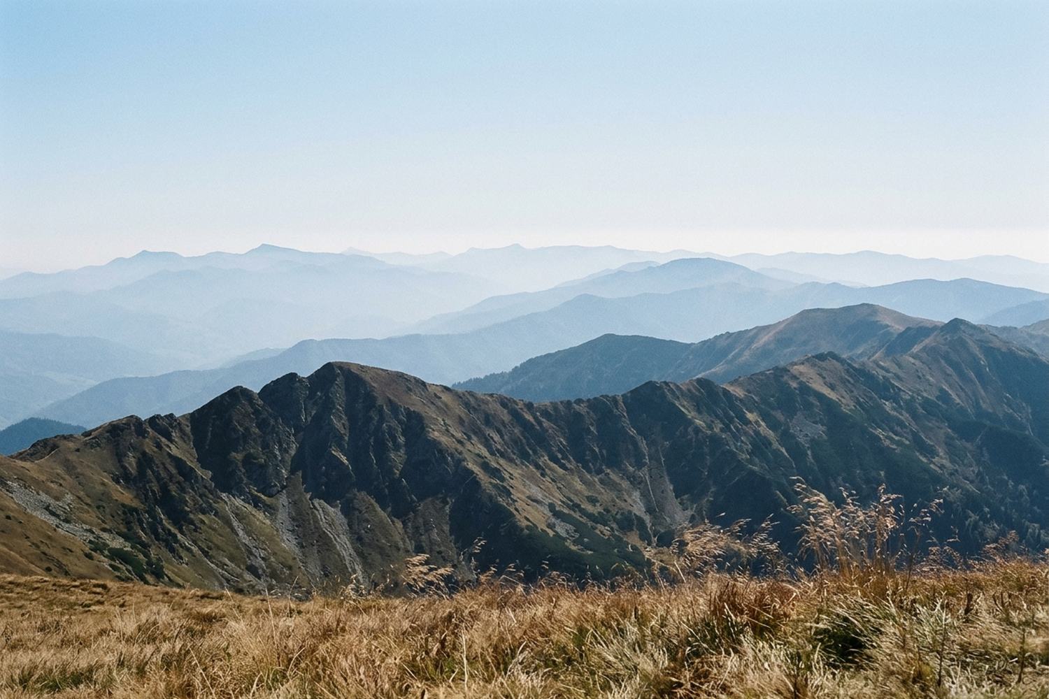 Range behind range of mountains fading into paler and paler blue.